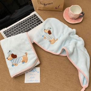 Close-up of soft coral velvet hair towel with cute dog embroidery and pink wavy edges