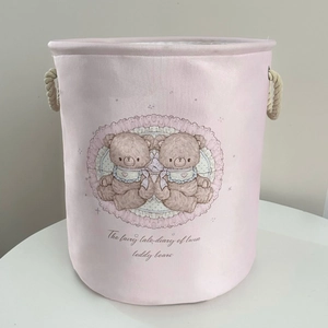 Pink laundry basket with teddy bear prints and thick cotton rope handles detail