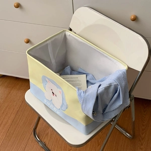 Detail view of foldable yellow and blue storage basket with cute puppy print and text