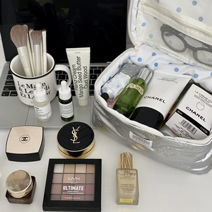 Silver quilted cosmetic bag detail with luxury skincare and makeup essentials inside