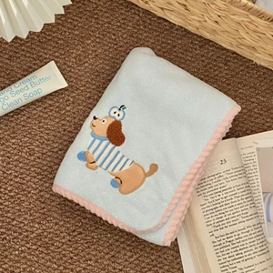 Detail of light blue coral fleece towel featuring cute embroidered cartoon dachshund