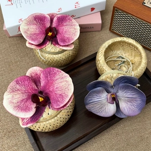 Three-piece bamboo storage box set decorated with artificial orchids for wedding decor