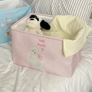 Detail of pink cat and blue puppy fabric storage baskets in a cozy bedroom setting