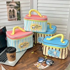 Detail of four cartoon lunch bags with striped patterns and sturdy yellow handles