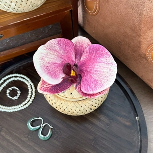 Bamboo woven jewelry box featuring a purple orchid flower with elegant pearl and jade jewelry