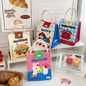 Detail of four cute cartoon canvas lunch bags with cotton rope handles and velcro closure