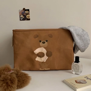 Detail of a brown canvas storage basket with a cute bear print and rope handles for home