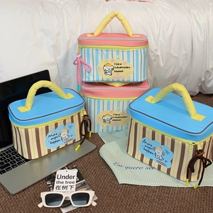Detail of striped lunch bags with cartoon embroidery and reinforced yellow handles