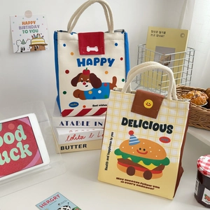 Detail of insulated lunch bags with cute cartoon prints and sturdy canvas fabric
