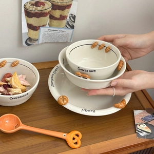 Ceramic tableware set with 3D embossed bread designs and warm creamy white glaze
