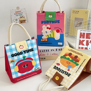 Detailed view of canvas lunch bags with cute cartoon patterns and velcro closures