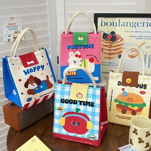 Detail of insulated lunch bags featuring cute cartoon patterns and durable handles