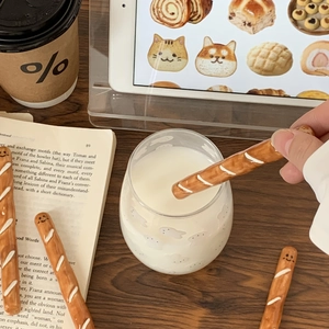 Creative baguette ceramic stirrer stick with cute smiley face shown in a cozy coffee setting