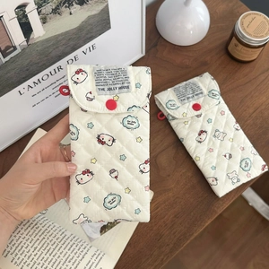 Detailed view of quilted Hello Kitty glasses pouch with red button and star pattern