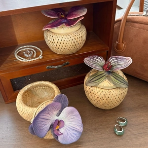 Three-piece bamboo orchid gift boxes on wooden surface with elegant vintage decor