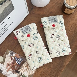 Detailed view of quilted cotton glasses pouch featuring cartoon cat patterns and red button