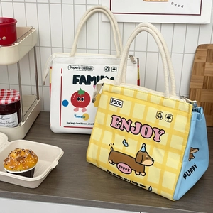 Detail of insulated lunch bags with tomato and dachshund prints on kitchen counter