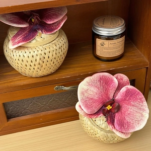 Close-up of bamboo woven storage boxes with orchid flowers for wedding decorations