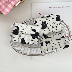 Detail of canvas cat print organizers in a metal basket showing three functional pouches