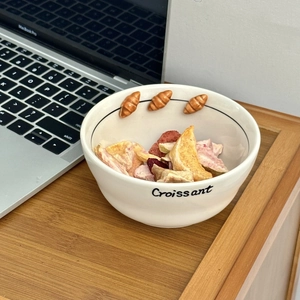 Ceramic croissant relief bowl for desserts with elegant 3D pastry details on wooden table