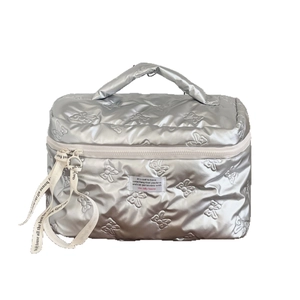 Silver quilted makeup bag with butterfly embossed pattern and handle for travel storage