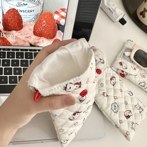 Close-up of quilted cartoon cat sunglasses pouch with soft padding and red button