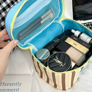 Detail view of striped puppy makeup bag showing large capacity mesh compartments
