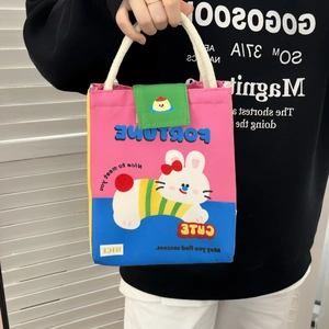 Detail of cute canvas lunch bag with cartoon rabbit print and durable cotton rope handle
