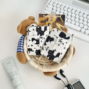 Detailed view of two cute cat pattern fabric coin purses in a cozy lifestyle setting
