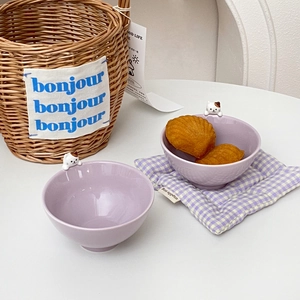 Detail of lavender ceramic cat bowls with cute sculpted kitten figurines on the rim