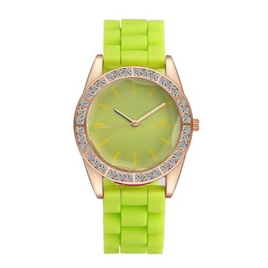Detail of Michael Kors fluorescent green silicone watch with rose gold diamond bezel