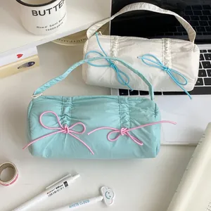 Detailed view of candy color bow pencil cases with soft quilted nylon fabric and zipper