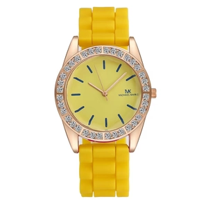 Macro detail of rose gold bezel with rhinestones and yellow silicone watch strap