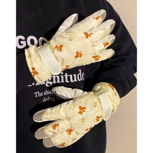 Detail view of winter gloves with bear print, anti-slip palm, and adjustable wrist strap
