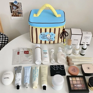 Top view of striped makeup bag with yellow handle and cartoon koala print details