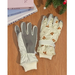 Close-up of winter ski gloves with cute bear pattern, non-slip palms and warm fleece lining