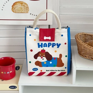 Close-up of cute cartoon dog lunch bag with red lid and sturdy rope handles on display