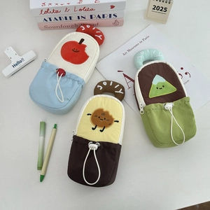 Close-up of canvas stationery pouches with JOLLY embroidery and cartoon fruit patterns