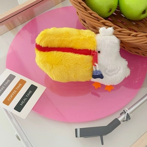 Detail of cute pelican plush makeup bag with red zipper and orange flipper feet decor