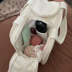 White quilted cosmetic bag with large capacity for travel toiletries and makeup items