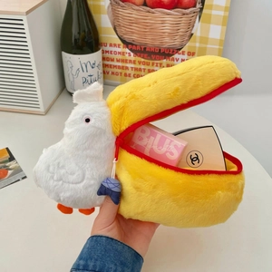 Detail of plush pelican storage bag featuring a large beak zipper and interior space