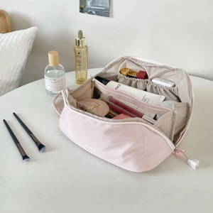 Detailed interior of the pink cosmetic bag with multiple compartments for easy storage