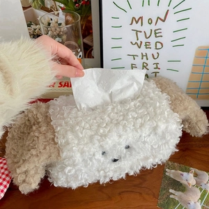 Close-up of curly plush puppy tissue box holder with hand extracting paper from top opening
