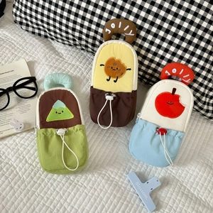 Macro detail of JOLLY embroidered pencil pouches with cartoon patches and drawstring pockets