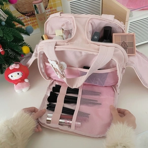 Pink multi-compartment makeup bag with brush slots and mesh pockets for travel
