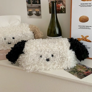 Detail of plush puppy tissue covers in white and brown curly faux fur for home decor