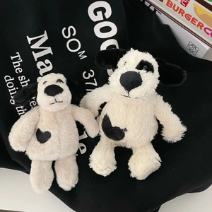 Detail of plush puppy charms with soft black spotted ears and heart embroidery