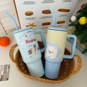 Close-up of 1200ml stainless steel tumblers with cute cartoon dogs and straw in a basket