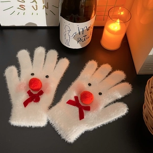 Close-up of white plush snowman gloves with red bow and fuzzy pom-pom nose details