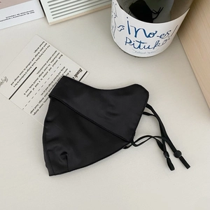 Detailed view of black mulberry silk UV face mask with adjustable ear loops and soft texture